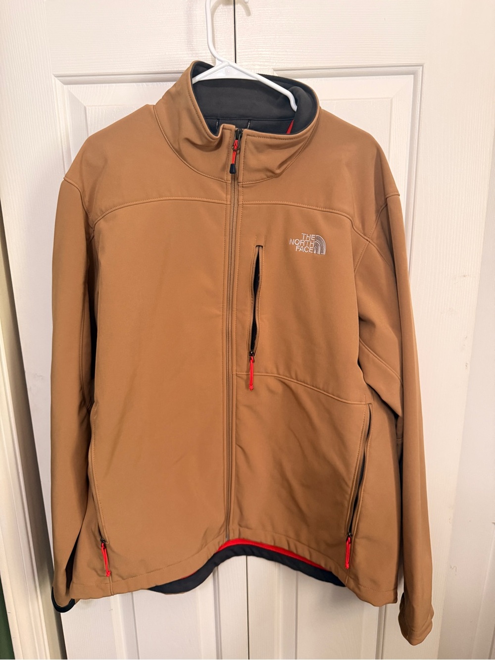 The North Face Men's Tan Softshell Jacket with Red Zipper Accents